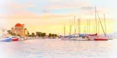 View of Ekklisia Isodia Theotokou church and sail boats  in the