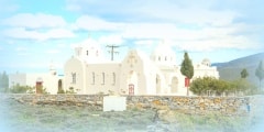 White church at the side of the road at Tinos