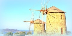 Windmills in the setting sun on the island of Patmos. Dodecanese
