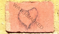 Crude love heart graffiti on red brick