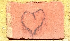 Crude love heart graffiti on red brick
