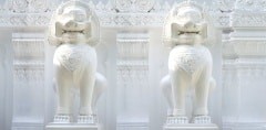 two white lion statue in thailand temple.