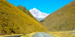 road to village Sno, caucasus mountains, mountain river, snowy p