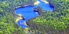 Aerial view of a lake in the middle of wild canadian forest
