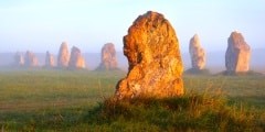 Menhir alignment view at Camaret sur mer at sunrise during fog