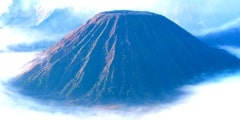 Mount Bromo, an active volcano surrounded by white clouds of mist in the morning at the Tengger Semeru National Park in East Java, Indonesia.